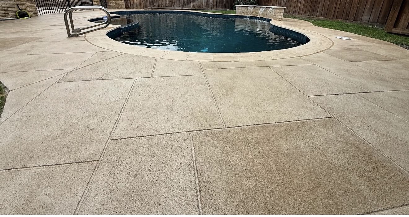 Warm cream decorative pool deck coating around a backyard pool