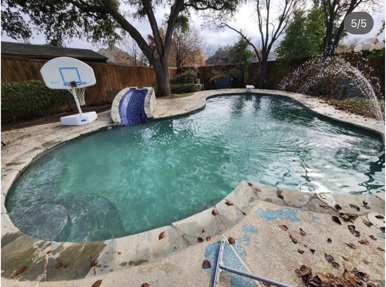 Before renovation: worn pool deck with peeling coating
