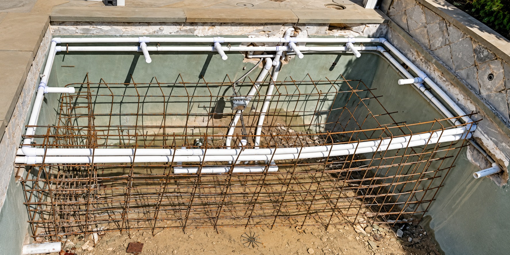 Spa under construction with reinforcing steel and PVC jet plumbing